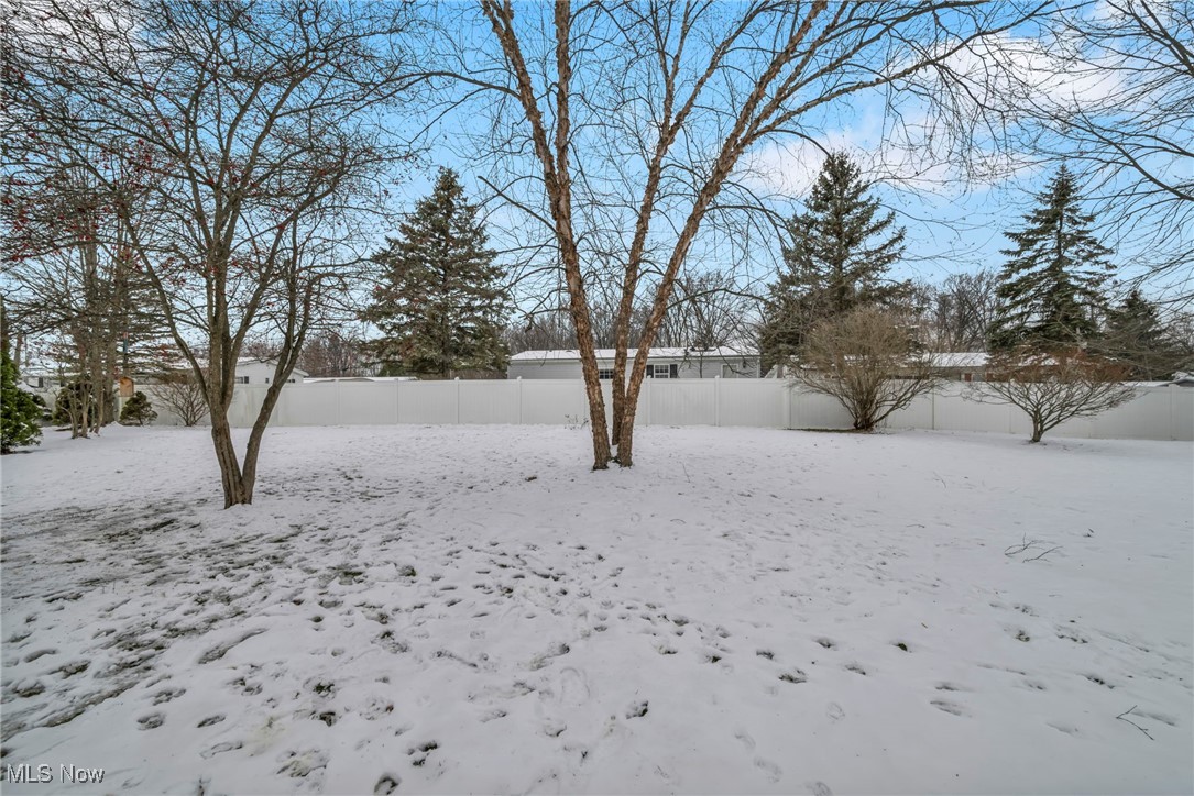 27202 Cook Road, Unit 95 Olmsted Falls, OH 44138 - Photo 40 of 46 Snowy yard with a fenced backyard