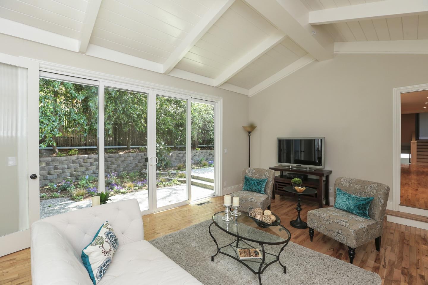 424 Sims Road Santa Cruz, CA 95060 - Photo 14 of 37 a living room with furniture a flat screen tv and a large window
