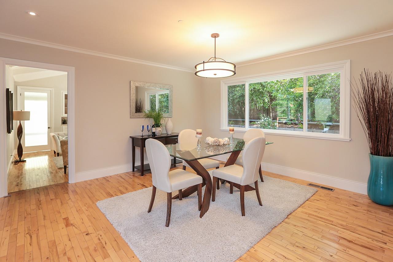 424 Sims Road Santa Cruz, CA 95060 - Photo 15 of 37 a dining room with wooden floor a chandelier a wooden table and chairs