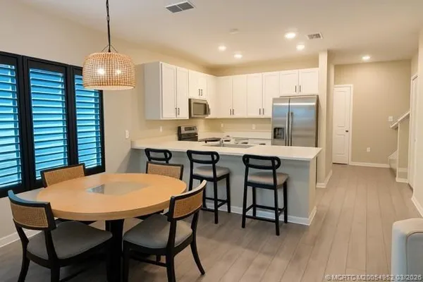 a view of a dining room with furniture and wooden floor