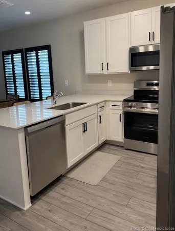 a kitchen with stainless steel appliances granite countertop a stove and a sink