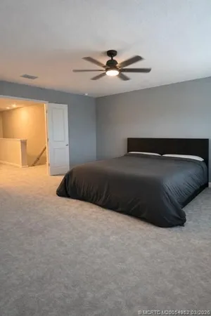 a bedroom with a bed and window