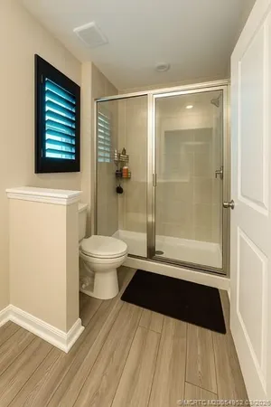 a bathroom with a toilet a sink and a shower