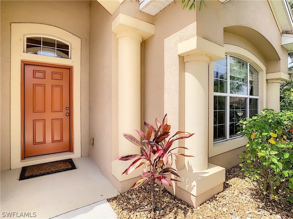 2816 Via Piazza Loop Fort Myers, FL 33905 - Photo 1 of 34 a potted plant sitting in front of a door