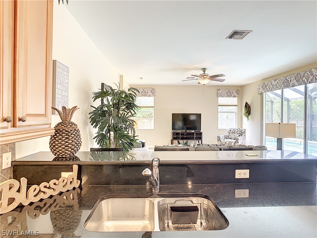 2816 Via Piazza Loop Fort Myers, FL 33905 - Photo 11 of 34 a kitchen with a sink and a refrigerator