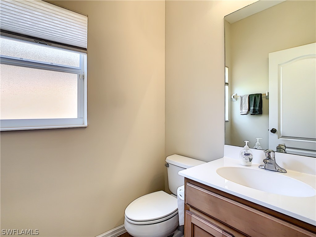 2816 Via Piazza Loop Fort Myers, FL 33905 - Photo 14 of 34 a bathroom with a sink a toilet and mirror
