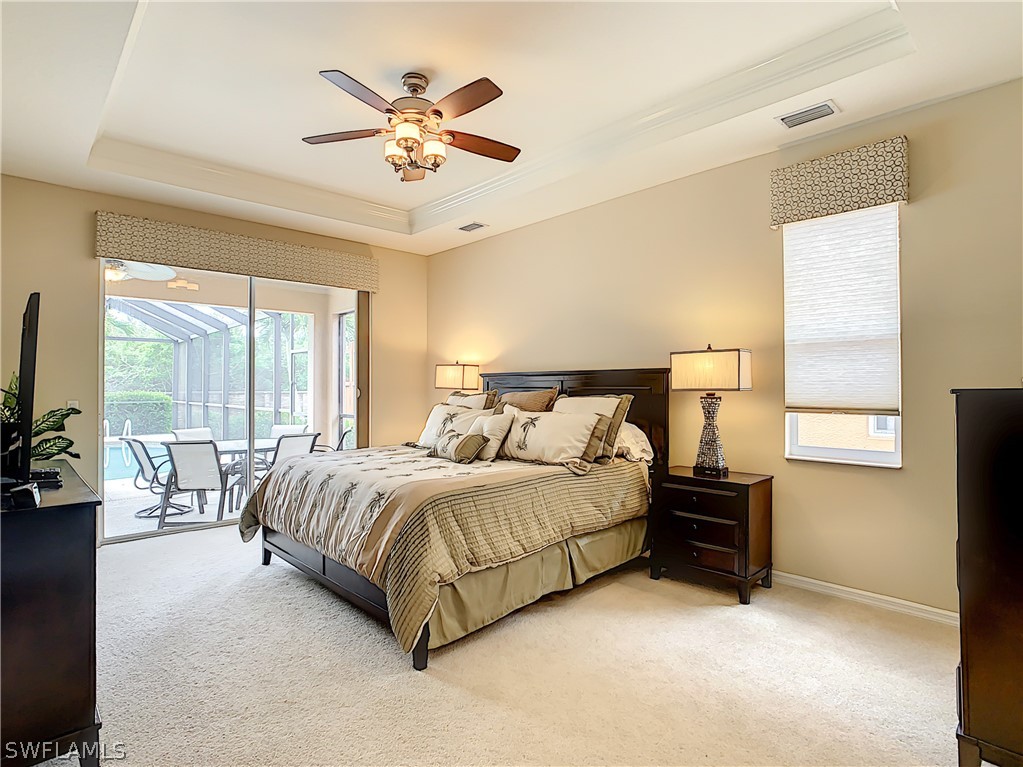 2816 Via Piazza Loop Fort Myers, FL 33905 - Photo 17 of 34 a spacious bedroom with a bed and a chandelier