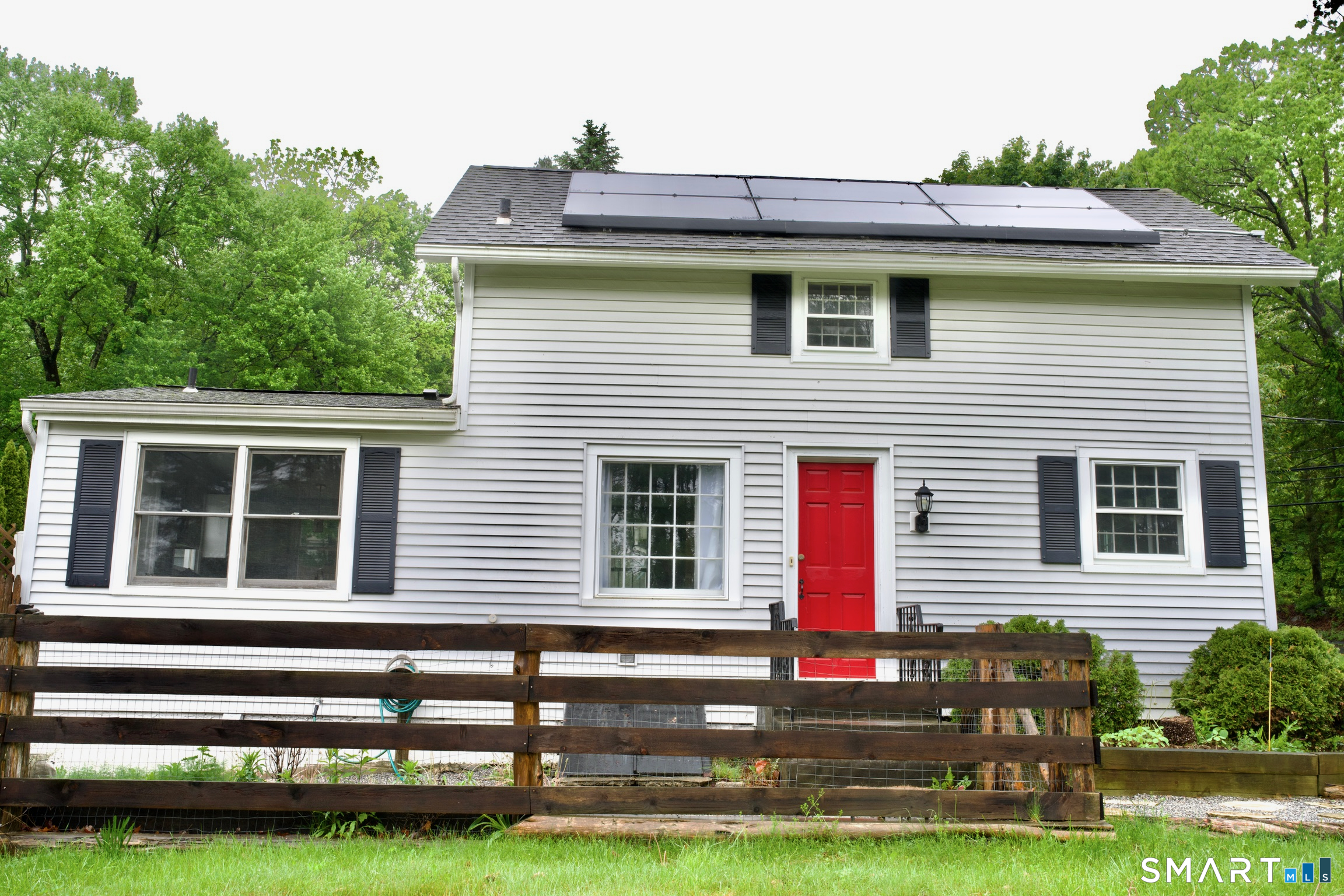 259 Peck Hill Road Woodbridge, CT 06525 - Photo 2 of 32 a front view of a house with a garden and plants