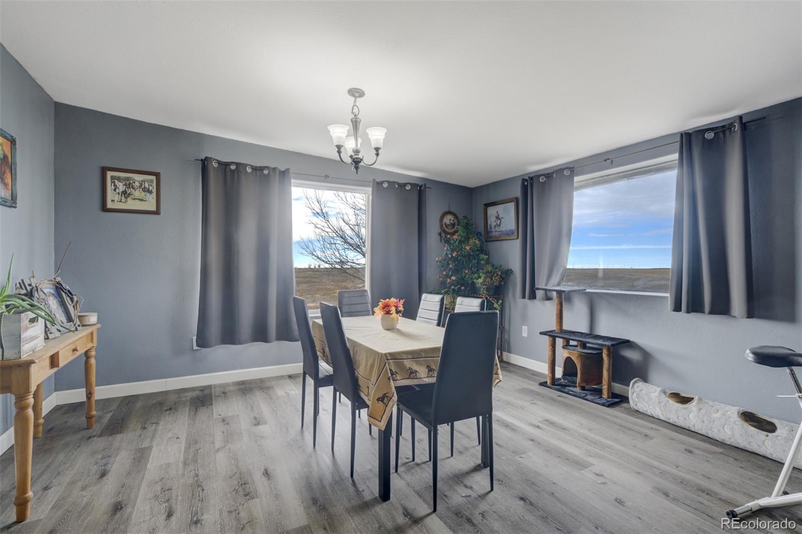 53647 County Road Genoa, CO 80818 - Photo 19 of 47 a view of a dining room with furniture window and wooden floor