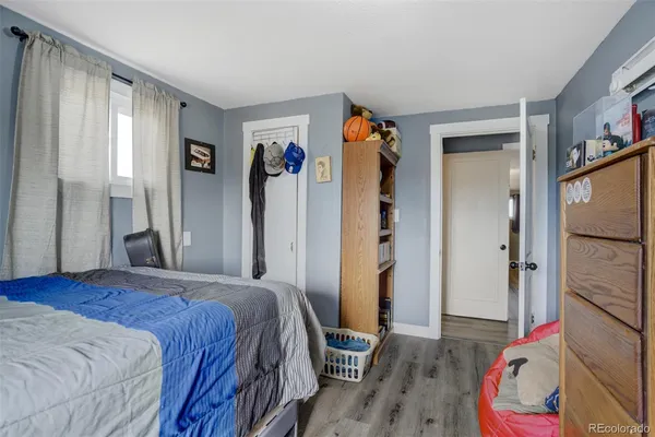 a bedroom with a bed and a painting on the wall