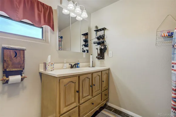 a bathroom with a sink toilet vanity and shower