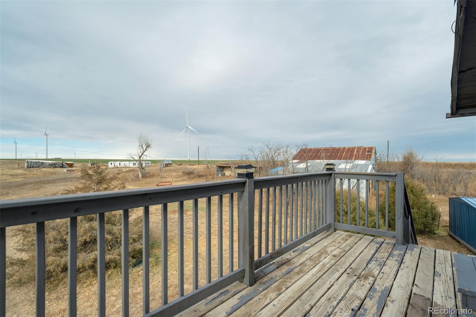53647 County Road Genoa, CO 80818 - Photo 35 of 47 a balcony with wooden floor and city view