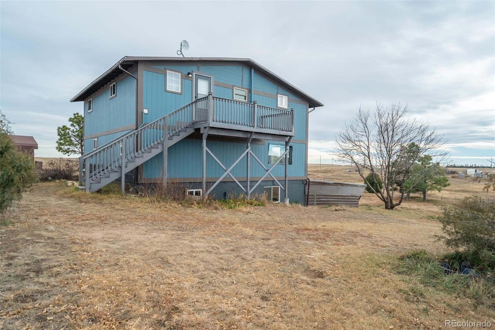 53647 County Road Genoa, CO 80818 - Photo 36 of 47 a view of a house with a yard