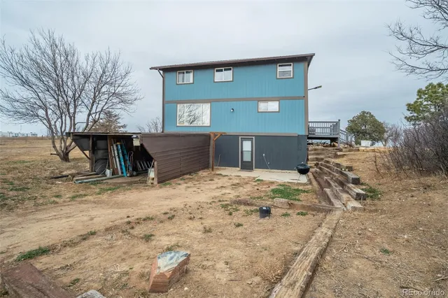 a view of a house with wooden fence