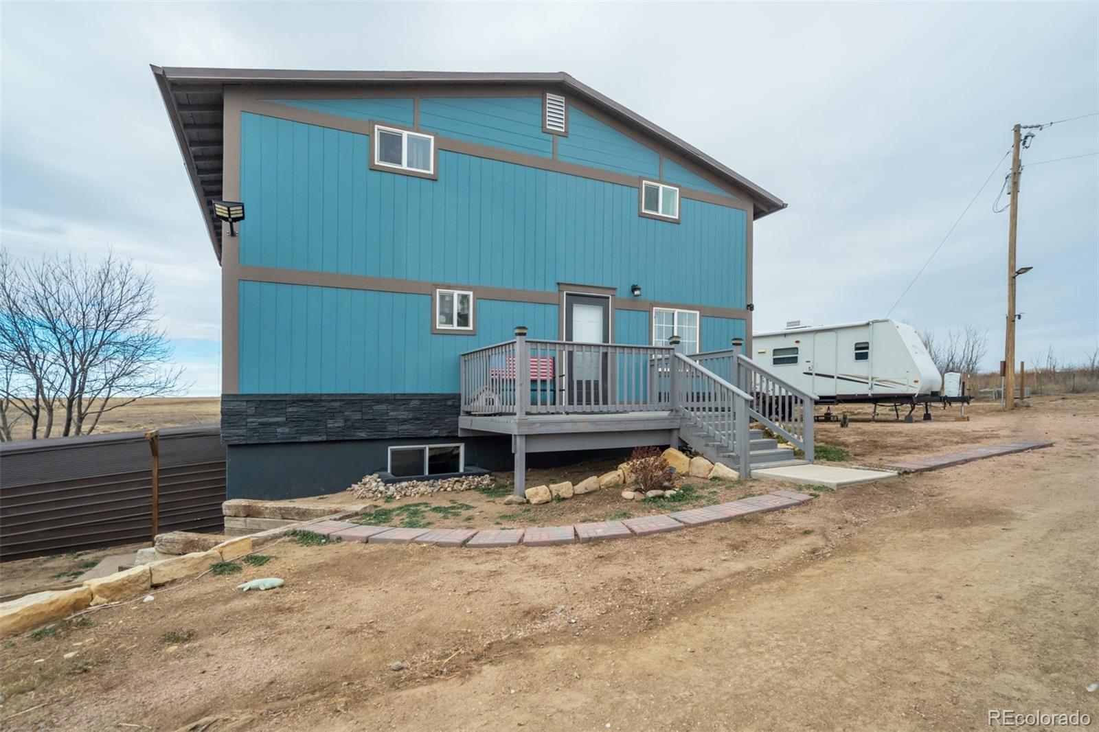 53647 County Road Genoa, CO 80818 - Photo 41 of 47 a backyard of a house with fire pit and chairs