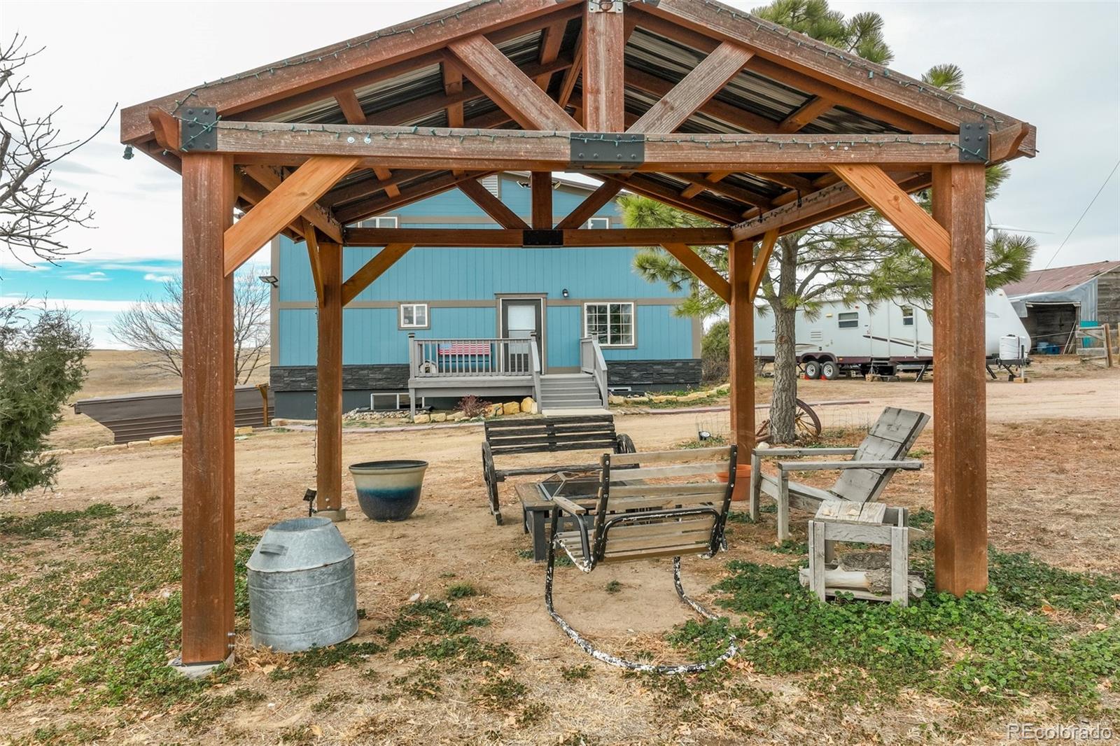 53647 County Road Genoa, CO 80818 - Photo 10 of 47 a patio with a patio table and chairs