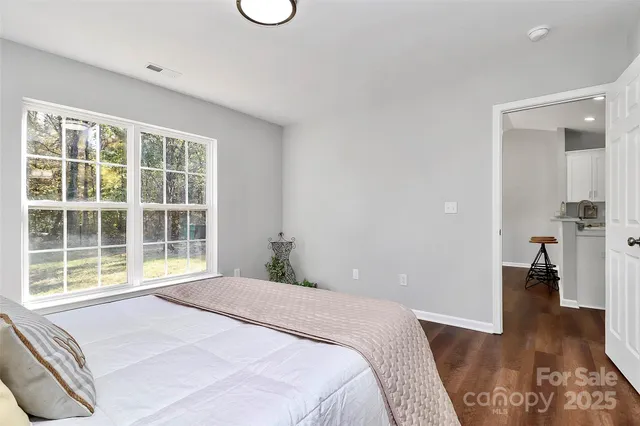 a bedroom with a bed and a large window