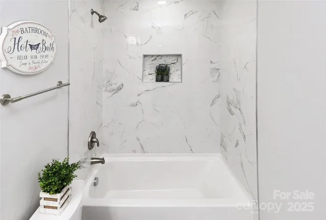 a bathroom with a bathtub and shower