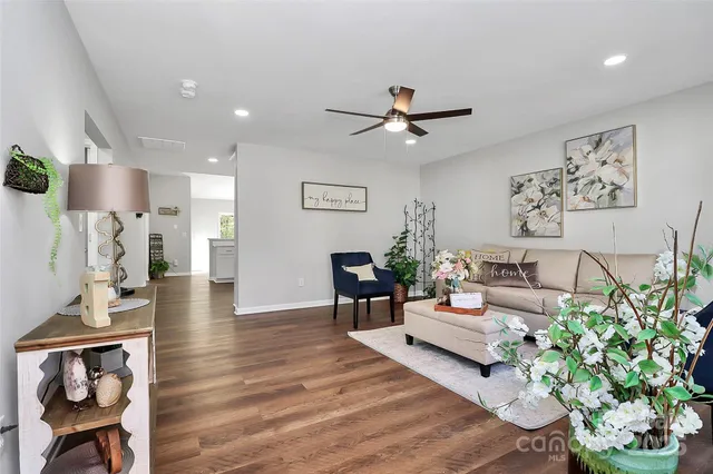 a living room with furniture and a chandelier