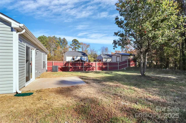 a backyard of a house with table and chairs