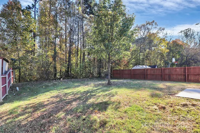 a front view of a house with a garden and plants