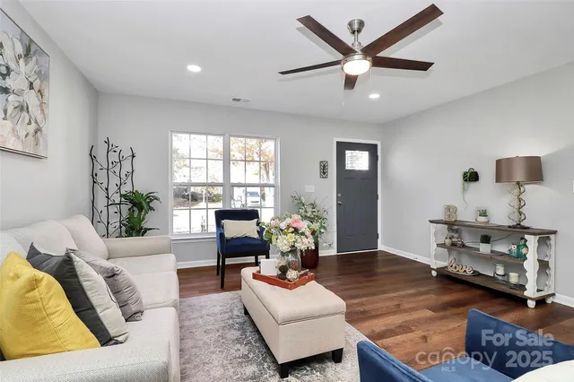a living room with furniture and wooden floor