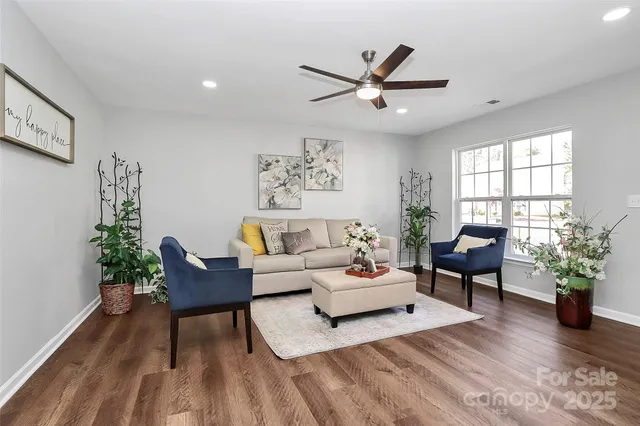 a living room with furniture and a potted plant