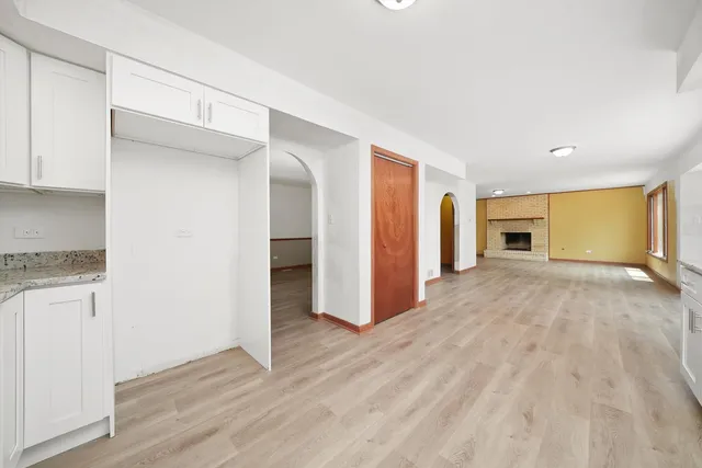 a view of a livingroom with wooden floor and a window