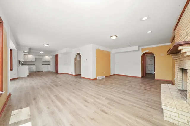 a view of a kitchen with a refrigerator and a window