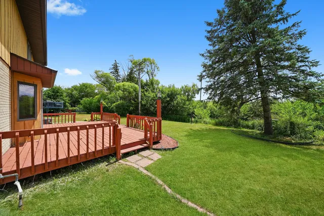 a view of a house with a yard and porch