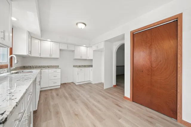 a kitchen with a refrigerator sink and cabinets