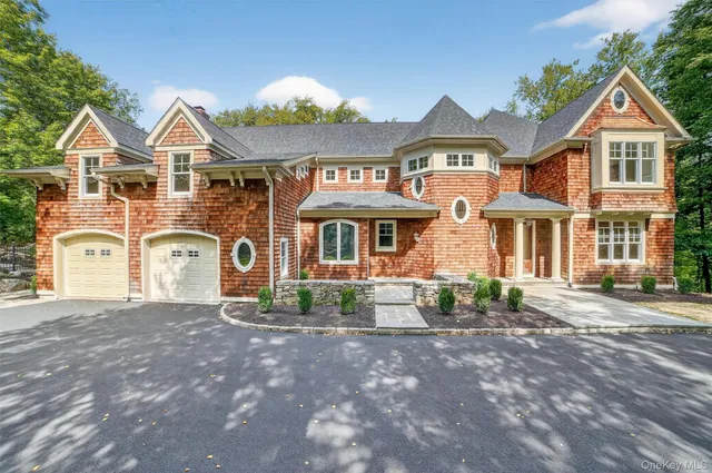 a front view of a residential houses with yard