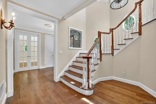 a view of entryway with wooden floor and stairs