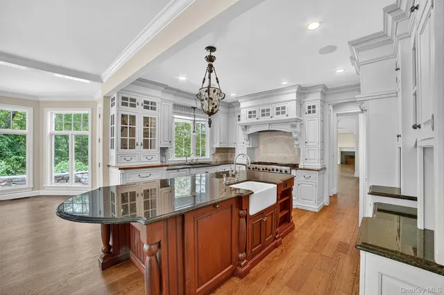 a kitchen with stainless steel appliances granite countertop a stove and cabinets