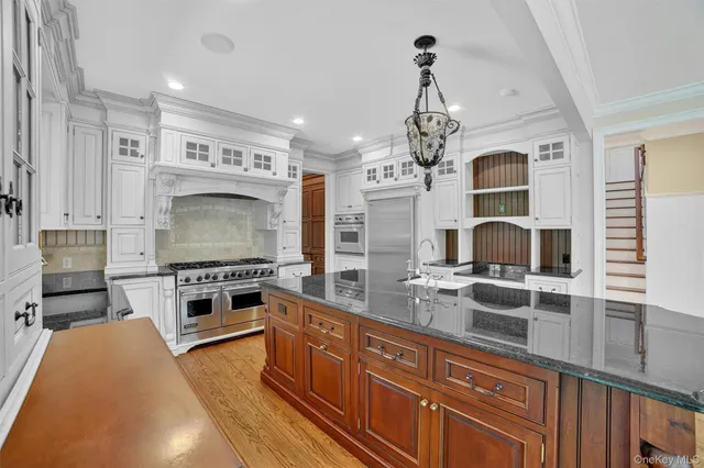 a kitchen with stove a sink and refrigerator