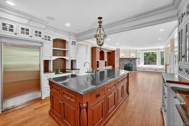 a kitchen with stainless steel appliances granite countertop a sink and a stove