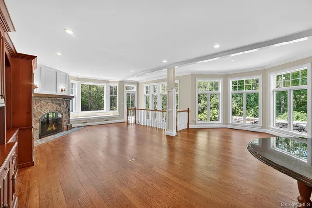 a view of empty room with wooden floor and fireplace