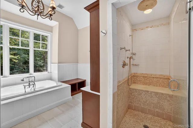 a bathroom with a tub shower and sink