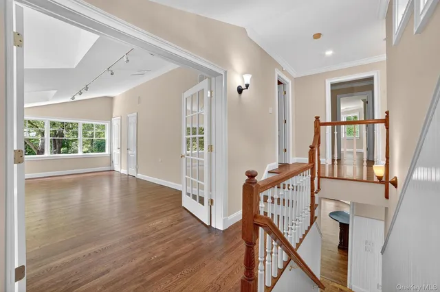 a view of an entryway with wooden floor and stairs