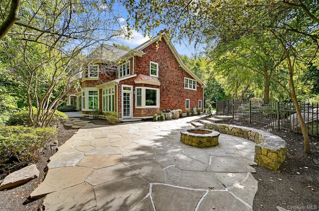 a front view of a house with a yard and sitting area