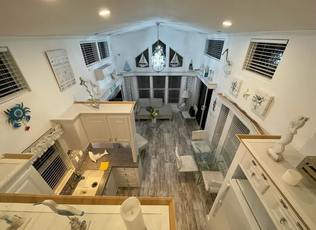 front view of a kitchen with granite countertop lots of appliances