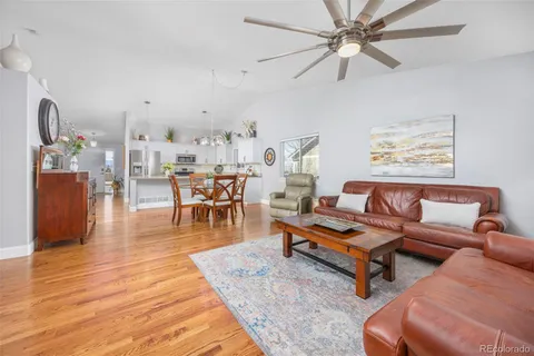 a living room with furniture and wooden floor