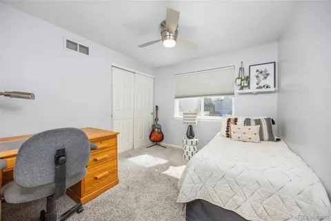 a bedroom with bed and a chandelier