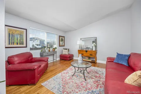 a living room with furniture and a rug