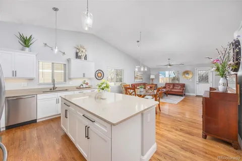 a open kitchen with stainless steel appliances granite countertop a lot of counter space and wooden floors