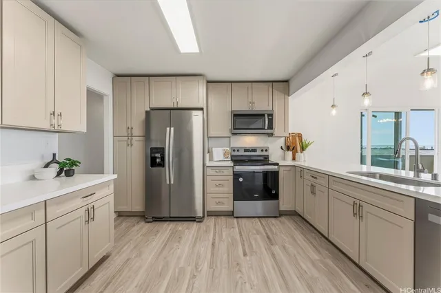 a kitchen with a sink stainless steel appliances and cabinets