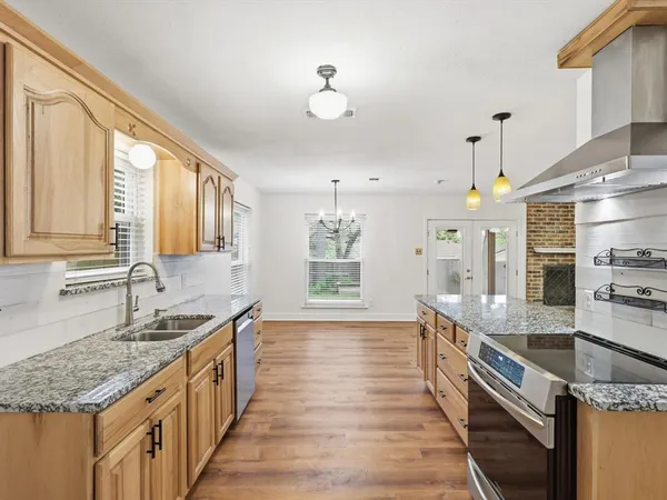 a large kitchen with granite countertop a large counter top and sink
