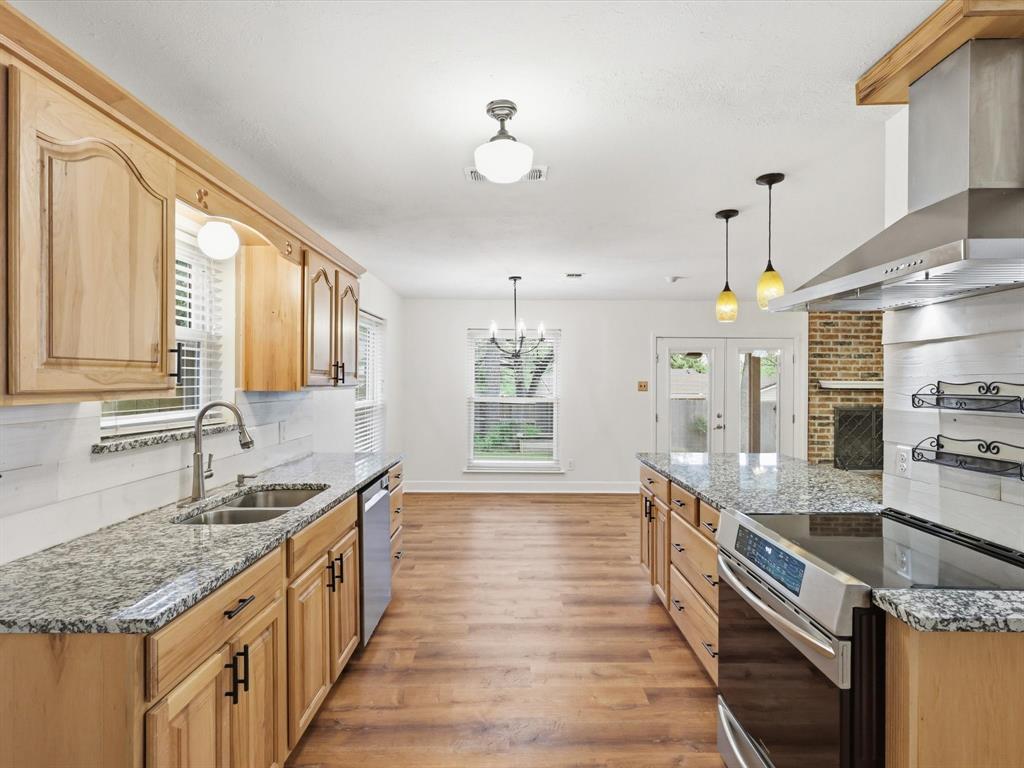 209 Valley View Court Azle, TX 76020 - Photo 14 of 39 Kitchen featuring light stone counters, tasteful backsplash, and stainless steel appliances