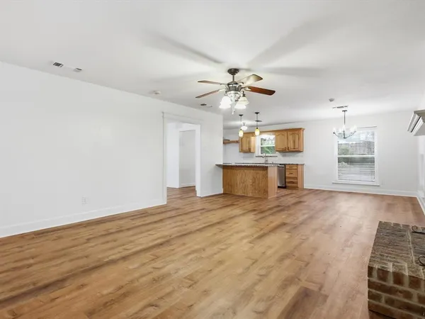 wooden floor in an empty room with a fireplace