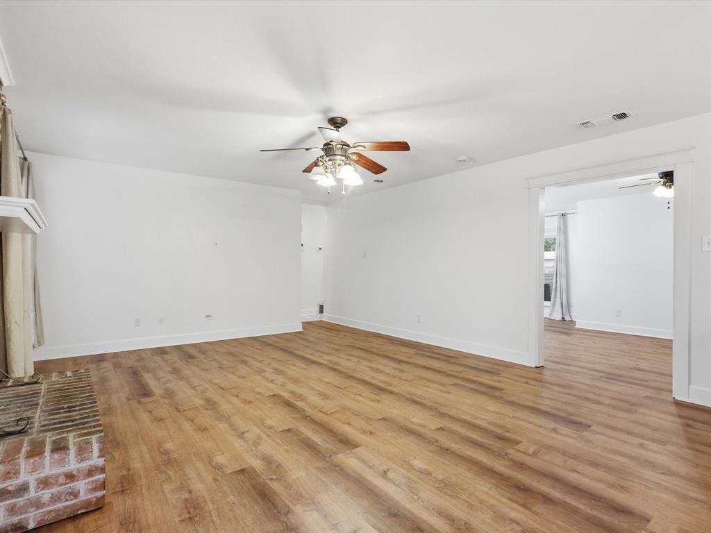 209 Valley View Court Azle, TX 76020 - Photo 19 of 39 Unfurnished living room featuring ceiling fan and light wood-style flooring